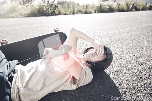 Image of Pain, skateboarder and man with arm injury on road after fall, accident or exercise workout outdoors. Sports emergency, skating and crying male with bleeding elbow, painful wound and broken bones.