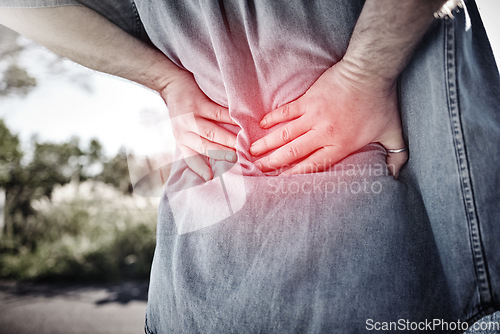 Image of Hands, sports fitness and man with back injury outdoors after accident or workout. Emergency, first aid and male with fibromyalgia, arthritis or inflammation and spine pain after exercise outdoors.