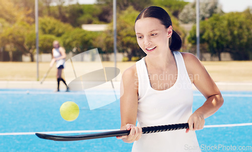 Image of Tennis, racket and woman with ball for training, fitness and balance, practice and cardio at an outdoor court. Sports, girl and athletic professional excited, happy and getting ready for performance