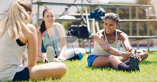 Image of Stretching, fitness and sports women with teamwork, support and exercise, wellness and health on grass or field. Training, workout and athlete group of people in diversity, talking and relax on floor