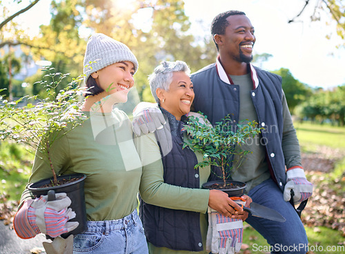 Image of Volunteer group, plants and gardening in a park with trees in nature environment, agriculture or garden. Happy man and women planting for growth, ecology and sustainability for community on Earth day