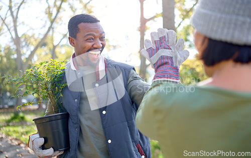 Image of High five, gardening and people in a garden happy and celebrating plant growth for sustainability in the environment. Volunteer, black man and team excited for planting as teamwork in a park