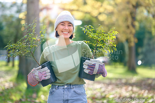 Image of Woman portrait, plant and gardening in a park with trees in nature environment, agriculture or garden. Happy volunteer planting for growth, ecology and sustainability for community on Earth day