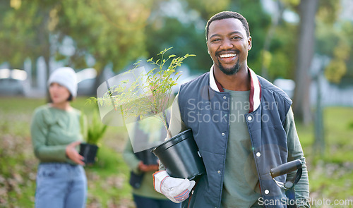 Image of Agriculture, portrait and black man with a plant in nature after doing sustainable gardening in a park. Happy, smile and eco friendly African male gardener standing with greenery on an outdoor field.