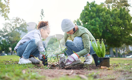 Image of Family, plant and gardening in a park with trees in nature environment, agriculture or garden. Volunteer woman and child planting for growth, ecology and sustainability for community on Earth day