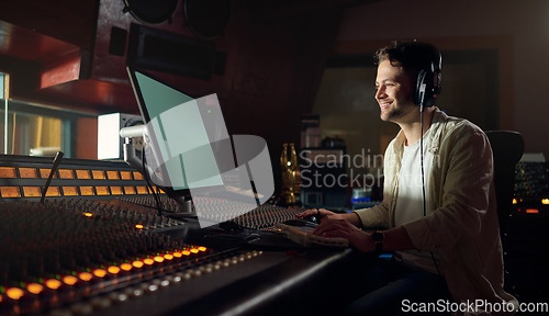 Image of Musician, smile or computer headphones in music recording, sound mixing or song composition in studio. Producer, DJ or happy man on technology and ideas for live streaming radio, audio or media album