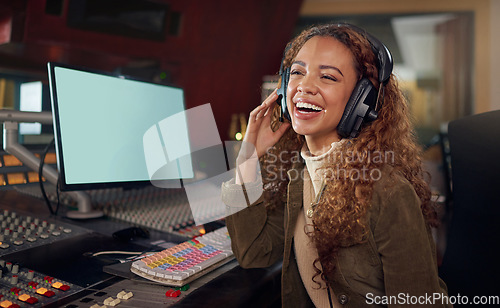 Image of Laughing, producer and music recording headphones for funny audio, comic sound or comedy radio in broadcast studio. Smile, happy or musician woman on computer tech, mockup screen or song composition