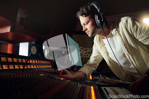 Image of Dj, thinking or recording headphones for music, sound mixing or computer song composition in studio. Musician, man or producer on technology with ideas for live streaming radio, audio or media album