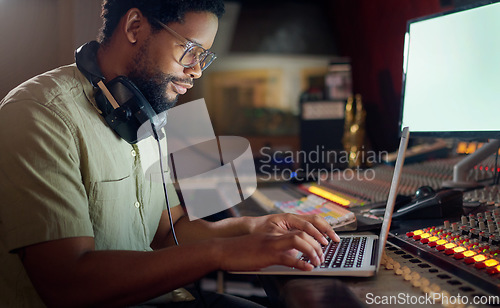 Image of Black man, thinking and laptop for music recording, sound engineering or song composition in studio. Producer, DJ and musician on technology with ideas for live streaming radio, audio or media album