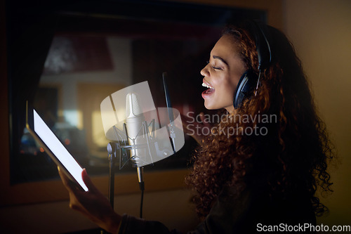 Image of Tablet, singing or musician on studio microphone, mockup music or mock up lyrics in night recording. Singer, woman or artist on technology in production app, voice media or sound performance practice