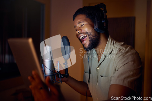 Image of Tablet, singer or black man on studio microphone, music app or live streaming lyrics in dark recording. Singing, musician or artist on technology production, voice media or sound performance practice