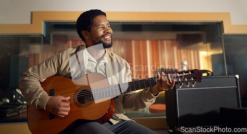 Image of Musician, acoustic and man playing the guitar for music production or recording in studio. Artist, guitarist and African guy strumming the strings of a musical instrument for sound track performance.