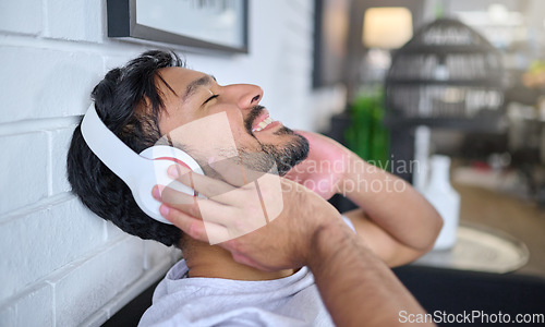 Image of Relax, music and man with headphones in home living room streaming radio or podcast. Freedom, technology and face of happy male in lounge listening to relaxing song, audio track or album in house.