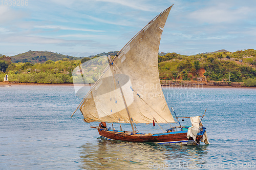 Image of Malagasy fisher on sea in traditional handmade dugout wooden sailing boat