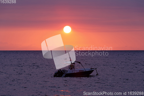 Image of Sunset over Madagascar Nosy be beach with boat silhouette