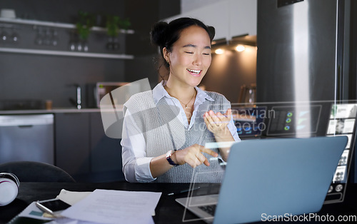 Image of Laptop, futuristic hologram and woman in home kitchen laugh at funny meme. Freelancer, remote worker and Asian female pointing to computer with 3d, augmented reality or data graphs at night in house