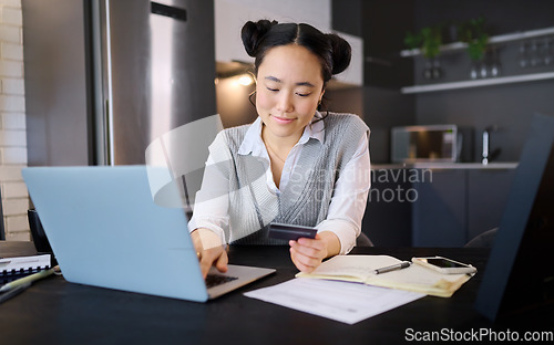 Image of Online shopping, credit card and Asian woman typing on laptop for banking or payment in home kitchen. Ecommerce, fintech and female with computer for buying, paying bills or finance budget at night.