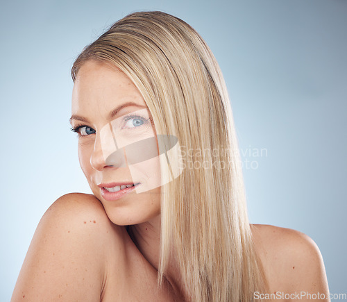 Image of Skincare, makeup and portrait of a woman with hair care isolated on a blue background in a studio. Spa, wellness and cosmetology model with facial makeup, cosmetics and dermatology on a backdrop