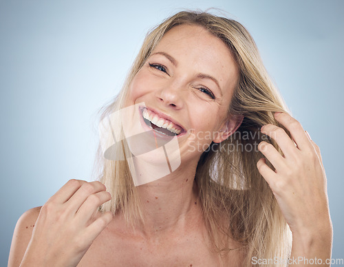 Image of Portrait, haircare or natural and a model woman in studio on a gray background with frizzy hair after treatment. Face, beauty and keratin with an attractive young female posing to promote cosmetics