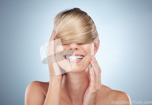 Image of Hair cover face, beauty and woman in studio isolated on a gray background. Texture, haircare mask and female model happy and satisfied after luxury salon treatment for balayage, hairstyle and growth.