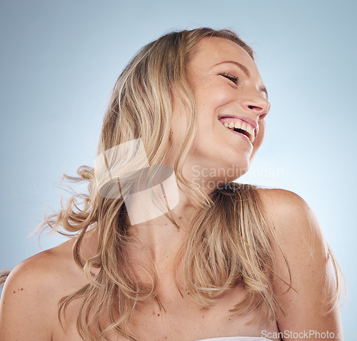 Image of Beauty, skincare and laughter with a model woman in studio on a gray background enjoying a joke or humor. Facial, cosmetics and funny with an attractive young female laughing for natural treatment