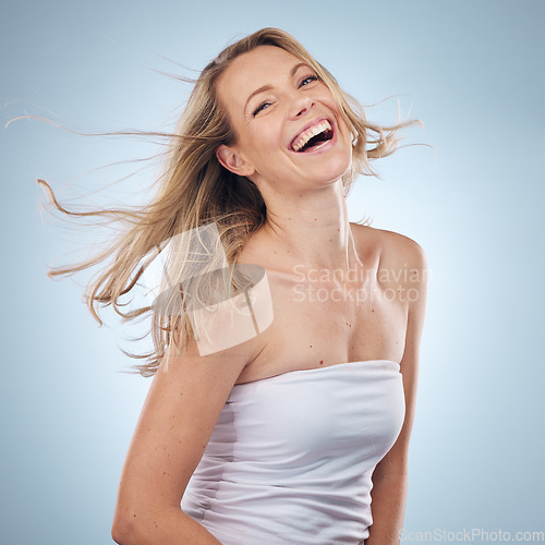 Image of Beauty, portrait and laugh with a model woman in studio on a gray background enjoying a joke or humor. Facial, skincare and funny with an attractive young female laughing for natural treatment