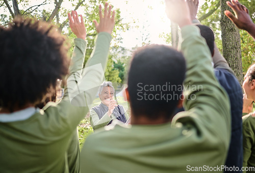 Image of Volunteer, cleaning and group with vote for a woman in a park for the community environment. Teamwork, happy and people with questions for a senior leader during a nature cleanup for sustainability