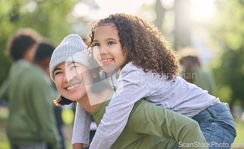 Image of Mother smile, piggy back hug and interracial family with girl and mom together in nature. Park, happy summer and mama with love and care for child playing outdoor in a garden with blurred background