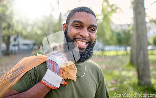 Image of Plastic bag, park and black man cleaning for earth day, eco friendly or community service in volunteering portrait. Recycle, trash or garbage of happy ngo person in nature or forest for pollution