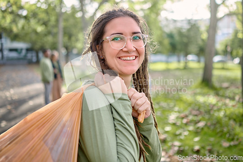 Image of Plastic bag, park and happy woman for eco friendly cleaning on earth day, community service or volunteering support. Recycle, trash or garbage of ngo person in portrait for nature or forest pollution