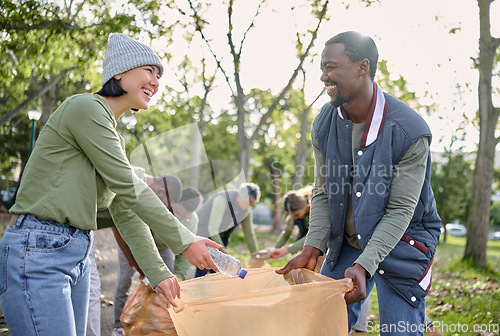 Image of Community volunteer, teamwork and cleaning park of plastic with garbage bag for a clean environment. Diversity man and woman help with trash for eco friendly lifestyle and recycling outdoor in nature