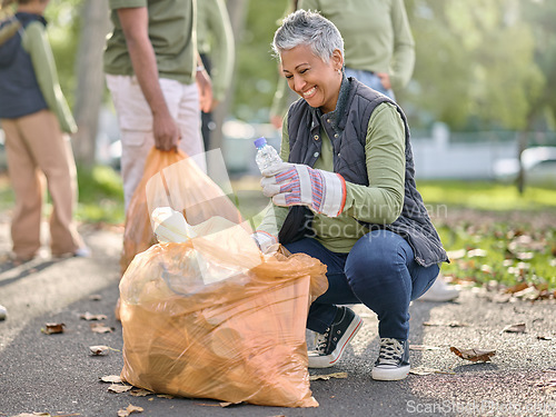 Image of Trash, volunteer and elderly woman cleaning garbage, pollution or waste product for environment support. Plastic bag container, NGO charity and eco friendly community help with nature park clean up