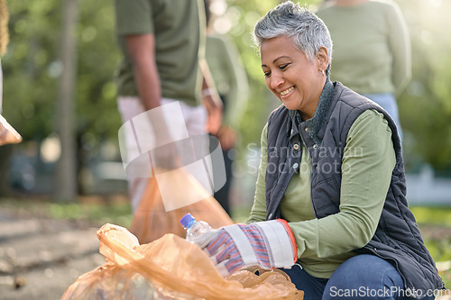 Image of Garbage, volunteer and senior woman cleaning trash, pollution or waste product for environment support. Plastic bottle container, NGO charity and eco friendly community help with nature park clean up