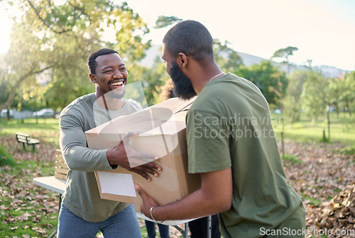 Image of Black man, charity and holding box in park of donation, community service or social responsibility. Happy guy, NGO workers and team helping with package for volunteering, support and society outreach