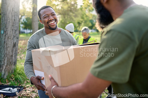 Image of Black man, volunteering and giving box in park of donation, community service or social responsibility. Happy guy, NGO worker and helping with package outdoor for charity, support or society outreach