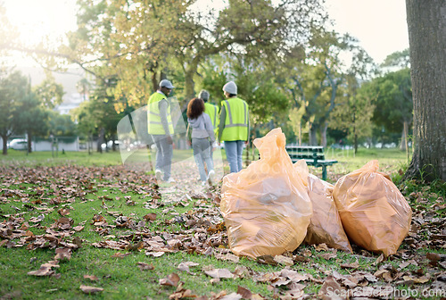 Image of Trash cleaning, plastic bag or community volunteer done with garbage, pollution or waste product clean up. Container, NGO charity or eco friendly people help with nature park for environment support