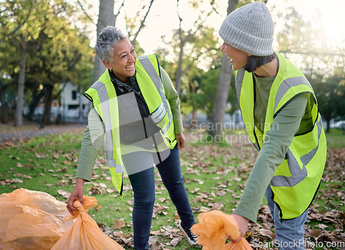 Image of Volunteer, happy women and community service while cleaning park with garbage bag for a clean environment. Team helping with trash for eco friendly lifestyle, ecology and recycling outdoor in nature