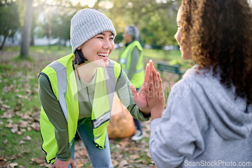 Image of High five, volunteer woman and child cleaning garbage pollution, waste product or community environment support. Teamwork celebration, NGO charity and eco friendly kid happy with nature park clean up