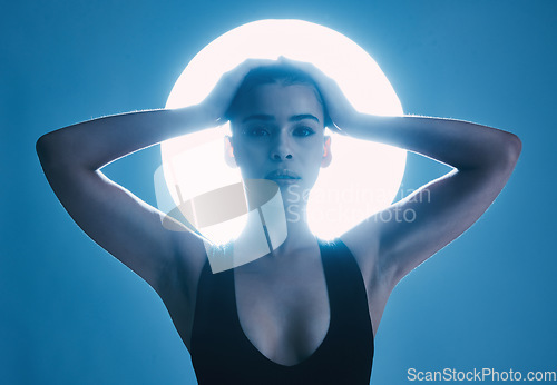 Image of Spotlight, vintage and portrait of a sexy woman with confidence isolated on a dark background in studio. Creative, fashion and aesthetic model with empowerment, pose and elegance on a backdrop