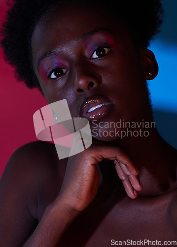 Image of Cool, aesthetic and portrait of black woman in dark color lighting isolated on a studio background. Neon, art and face of an African girl with creativity, makeup and stylish on a creative backdrop