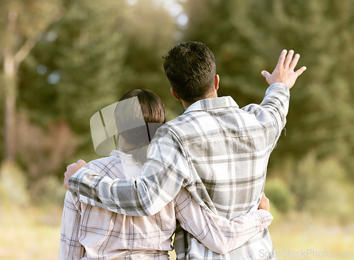 Image of Trees, nature gesture and couple hug on outdoor quality time together, hiking adventure or forest bonding journey. Peace, freedom and love for back of travel woman, man or people trekking in woods