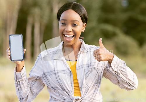 Image of Black woman, phone and thumbs up for winning on mockup display or screen for discount or sale in nature. Portrait of happy African American female smiling for giveaway prize, deal or 5G smartphone