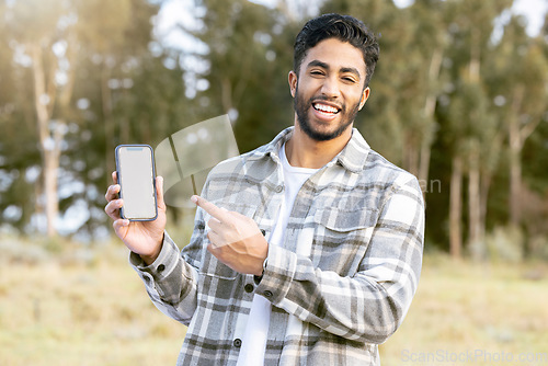 Image of Mockup, phone and portrait of man in nature or forest with mobile app, product placement or 5g technology promotion. Happy person, hand holding smartphone and space, mock up and screen in a park