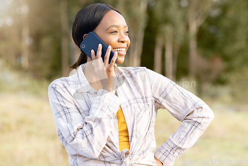 Image of Black woman, forest and phone call for talking, thinking and smile on grass in summer sunshine. Adventure holiday, comic smartphone conversation or funny talk for girl for networking, woods and joke