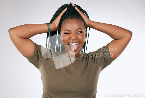Image of Comic, funny and black woman with a crazy face isolated on a grey studio background. Smile, happy and African girl model with tongue sticking out for comedy, happiness and goofy on a backdrop