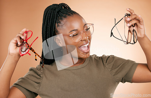 Image of Excited, glasses frame choice and black woman with a smile from eye care and retail product. Studio background, isolated and beauty of a young student feeling happiness about vision product shopping