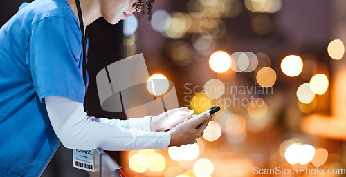 Image of Night, doctor and hands of woman texting in a city, relax and break outdoors against bokeh background. Female, mockup and young nurse with smartphone for app, planner and schedule, online and search