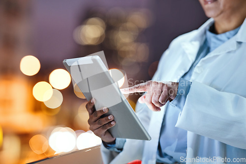 Image of Hands, tablet and healthcare with a doctor doing internet research outdoor on a hospital balcony at night. Medical, remote consulting and technology with a medicine professional outside at a clinic