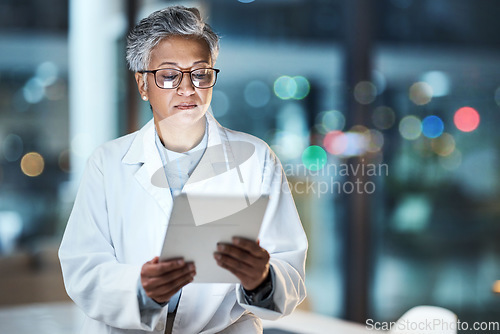 Image of Medical, research and night with doctor and tablet for planning, medicine and schedule. Technology, review and digital with senior woman reading report for healthcare, science and life insurance news