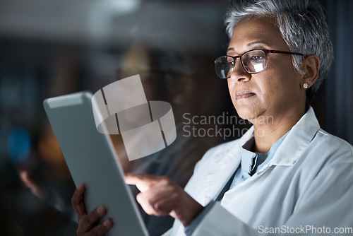 Image of Medical, research and night with doctor and tablet for planning, medicine and schedule. Technology, review and digital with senior woman reading report for healthcare, science and life insurance news